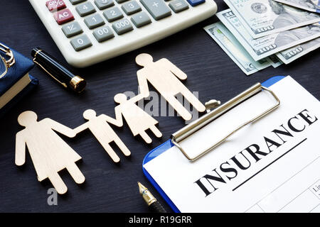 Life insurance. Policy and figures of family. Stock Photo