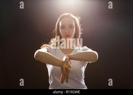 Young woman jazz funk dancer exercising dance moves in studio. Stock Photo