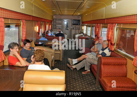 Passenger relaxing in the 1st class lounge /bar carriage on board The Ghan train.  The Ghan takes its name from the 19th century Afghan camel drivers  Stock Photo