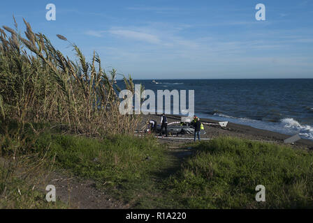 Malaga, MALAGA, Spain. 10th Nov, 2018. Police officers seen inspecting the dinghy after arriving on the beach with a group of migrants.A dinghy with migrants and two dead arrived at the Chilches beach near the coast of Velez MÃ¡laga, in Malaga. According to the media and witnesses, some of the migrants from Morocco escaped at the beach while the two corpses were found inside the small boat. Credit: Jesus Merida/SOPA Images/ZUMA Wire/Alamy Live News Stock Photo