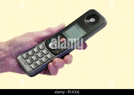 Elderly old senior hand holding mobile telephone taking scam fraud phone call Stock Photo