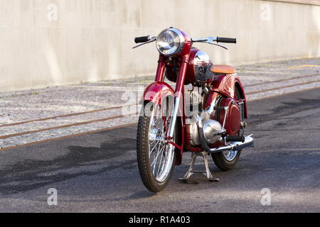 PRAGUE, CZECH REPUBLIC - MARCH 8 2018: Detail of red vintage motorcycle Jawa 125 produced in former Czechoslovakia standing on road on March 8, 2018 i Stock Photo