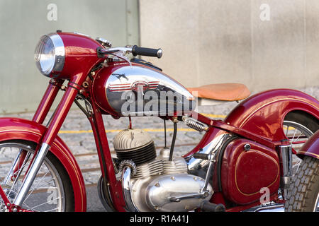 PRAGUE, CZECH REPUBLIC - MARCH 8 2018: Detail of red vintage motorcycle Jawa 125 produced in former Czechoslovakia standing on road on March 8, 2018 i Stock Photo