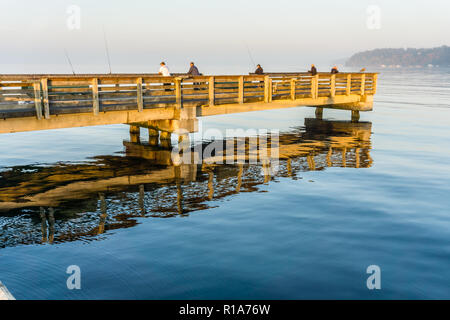 A view of fishermen on a wooden pier in Dash Point, Washington. Stock Photo