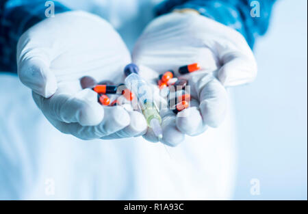Doctor hand holding Syringe and Medicines, Hospital Concept background Stock Photo