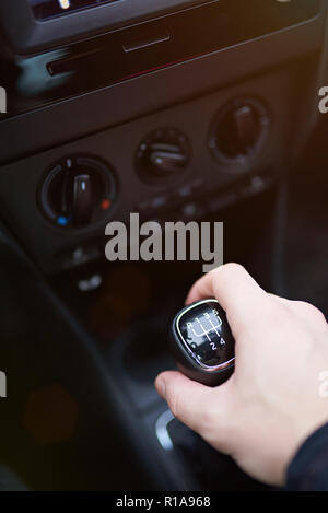 Hand on manual gear stick close up. Selecting gear on car Stock Photo