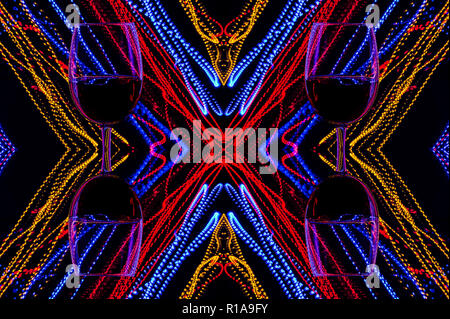 Glasses of wine on a background of abstract colored lights in motion. Multicolored lines of light on a black background. Stock Photo
