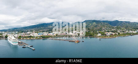 Papeete, Tahiti, French Polynesia. Aerial view of city skyline, sea port and marine from sea in a cloudy weather. Tahiti and her islands. Stock Photo