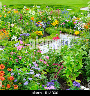 summer flower bed and green lawn Stock Photo