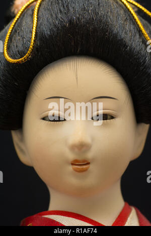 A closeup of the face of a traditional Japanese Geisha doll Stock Photo