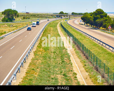 Vehicles crossing a european highway at a sunny day. Stock Photo