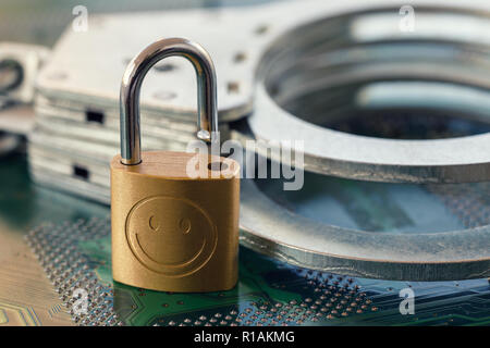 Digital security concept: Open lock on computer chip background with handcuffs Stock Photo