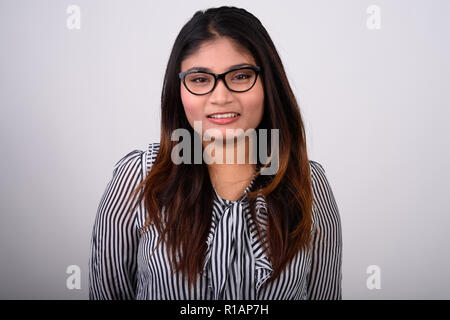 Close up of young happy fat Persian businesswoman smiling while  Stock Photo