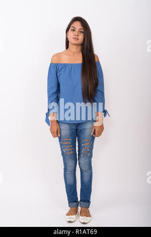 Full body shot of young Indian woman standing against white back Stock Photo