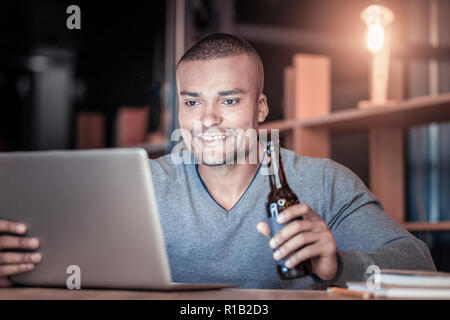 Concentrated young programmer checking news Stock Photo
