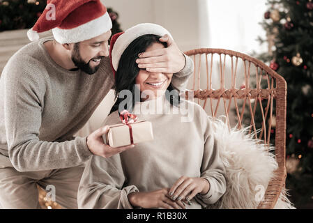 Attractive man presenting gift to his girlfriend Stock Photo