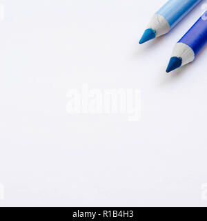 Two blue pencils isolated on white background. Stock Photo