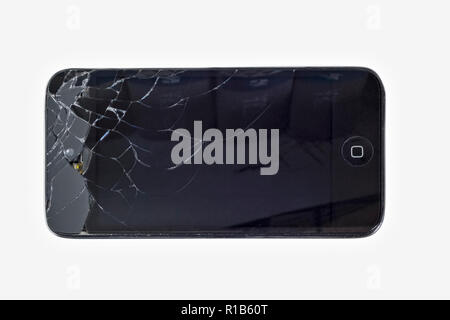 Smartphone black with  smashed shattered screen on a white background. Stock Photo