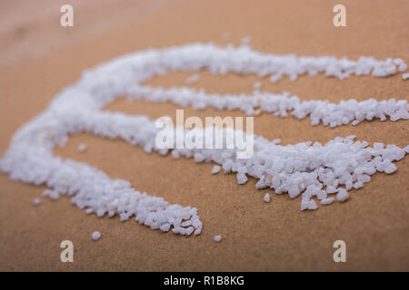 Small white sand scattered on a wooden background Stock Photo
