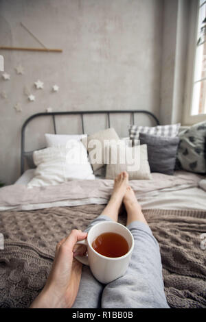 Crop woman having breakfast on bed Stock Photo