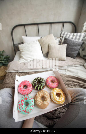 Crop woman having breakfast on bed Stock Photo
