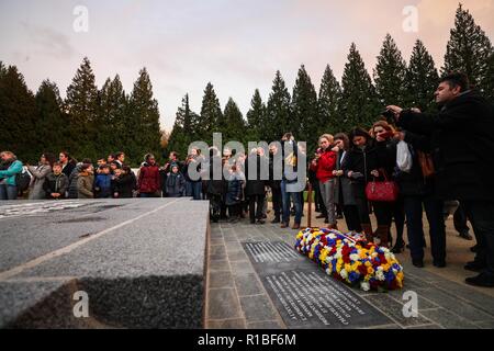 Paris, France. 10th Nov, 2018. People attend a ceremony to commemorate the 100th anniversary of the end of World War I, near the town of Compiegne, France, Nov. 10, 2018. French President Emmanuel Macron and German Chancellor Angela Merkel clasped hands on Saturday during a solemn joint ceremony at a historic site, in a vow of peace and unity. Credit: Zheng Huansong/Xinhua/Alamy Live News Stock Photo