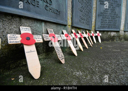 Bridport, Dorset, UK.  11th November 2018.  Small wooden crosses at the Remembrance Sunday service at the war memorial outside St Mary's Church in South Street in Bridport.  The 2018 Remembrance Day falls on the 100th Anniversary of armistice day which marks the ending of World War One.  Picture Credit: Graham Hunt/Alamy Live News Stock Photo