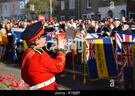 Bridport, Dorset, UK.  11th November 2018.  Standards are lowered during the last post at the Remembrance Sunday service at the war memorial outside St Mary's Church in South Street in Bridport.  The 2018 Remembrance Day falls on the 100th Anniversary of armistice day which marks the ending of World War One.  Picture Credit: Graham Hunt/Alamy Live News Stock Photo