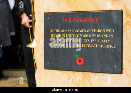 Yeadon, Leeds, West Yorkshire, UK 11th November, 2018. Close-up of the plaque inscription & red poppy motif on the new war memorial stone in front of Yeadon Methodist Church, on the anniversary of the end of the First World War. Ian Lamond/Alamy Live News Stock Photo