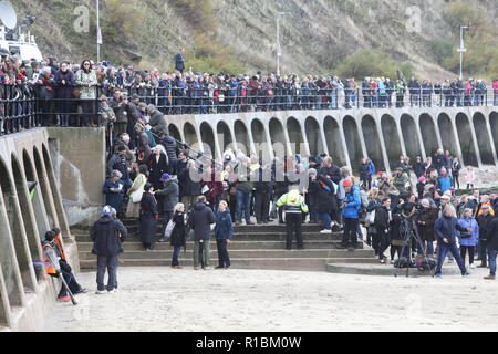 Folkestone, Kent, UK. 11th Nov, 2018. War poet Wilfred Own's face finally emerged from the beach at Sunny Sands as the sun came out. Danny Boyle arrived to join the 100s of people gathered to commemorate the Armistice Centenary. Credit: Monica Wells/Alamy Live News Stock Photo