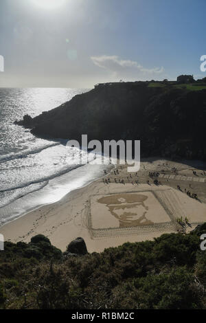 Porthcurno, Cornwall, UK. 11th Nov, 2018. A giant sand images was made on the beach at Porthcurno today. It was part of the 14-18 Now art commissions. This image depects RICHARD CHARLES GRAVES-SAWLE COLDSTREAM GUARDS AGE: 26 DATE OF DEATH: 02/11/1914 Son of Rear-Admiral Sir Charles Graves-Sawle, 4th Bart, and Lady Graves-Sawle, of 60, Queen's Gate, London; husband of Muriel Heaton-Ellis (now Mrs. A. L. C. Cavendish). Credit: Simon Maycock/Alamy Live News Stock Photo