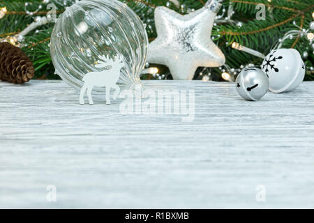 christmas decorations against green fir tree branch background with holiday lights Stock Photo
