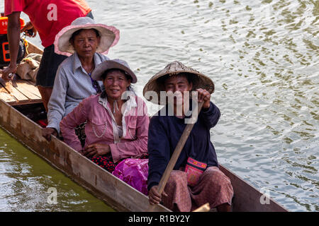 Don Khone, Laos - April 23, 2018: Local people navigating the Mekong on a wooden long boat near Cambodian border Stock Photo