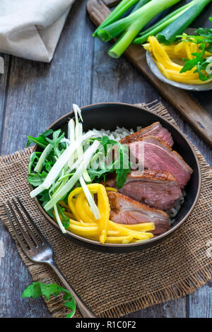 Hoisin duck with mango, spring onion, rocket lettuce salad and rice - top view Stock Photo