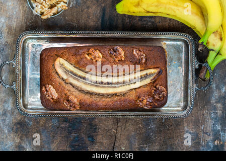 Homemade banana cake on rustic wooden table - top view Stock Photo