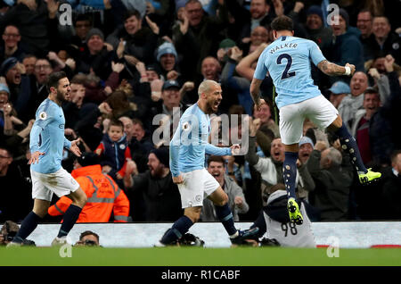 Manchester City's David Silva (second right) celebrates scoring his side's first goal of the game with team-mates Kyle Walker (right), Bernardo Silva (centre), Riyad Mahrez (second left) and Fernandinho (left) during the Premier League match at the Etihad Stadium, Manchester. Stock Photo