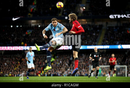 Manchester City's Kyle Walker (left) and Manchester United's Marouane Fellaini (right) battle for the ball during the Premier League match at the Etihad Stadium, Manchester.