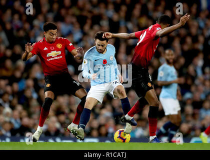 Manchester City's Bernardo Silva (centre) in action as Manchester United's Jesse Lingard (left) and Manchester United's Marcus Rashford (right) challenge for the ball during the Premier League match at the Etihad Stadium, Manchester.