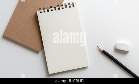 open blank spiral notebook with pencil and eraser on white background.Empty Space for your text. Stock Photo