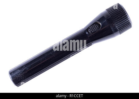 Old scratched black flashlight isolated on white background. Stock Photo