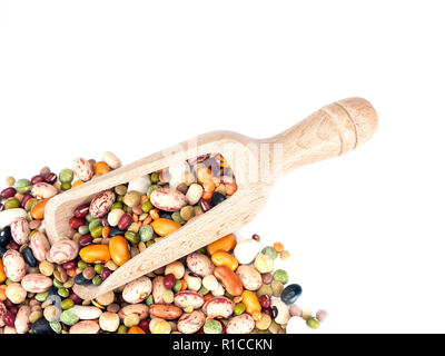 Assorted dried beans and lentils with wooden scoop on white background. Colorful healthy winter food ingredients. Stock Photo