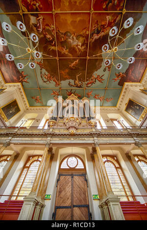 OXFORD, ENGLAND – MAY 15, 2009: The view of the Sheldonian Theatre interior with ornate theatre organ over the entrance and allegorical ceiling fresco Stock Photo