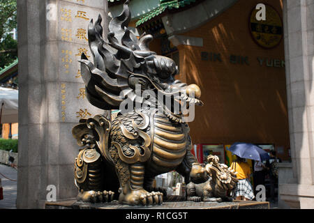 Sculpture stone Qilin dragon guardian at entrance of Wong Tai Sin Temple for people visit and respect praying at Kowloon on September 9, 2018 in Hong  Stock Photo