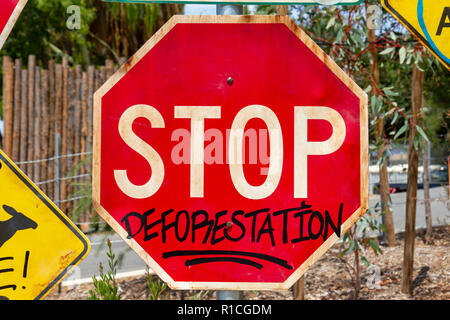 Road traffic sign adapted with environmentally friendly message ('STOP' sign says 'STOP DEFORESTATION', San Diego Zoo Safari Park, Escondido, CA, USA. Stock Photo