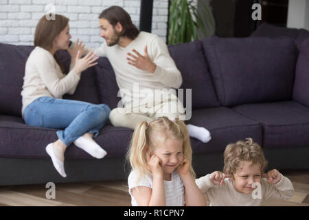 Parents with little preschool children at home quarrelling Stock Photo