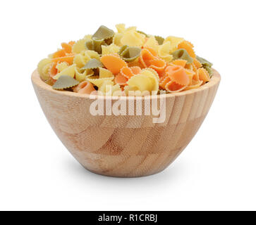 Multicolored pasta shells in a wooden bowl isolated on white background Stock Photo