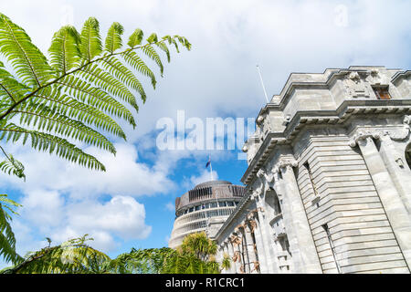 New Zealand Government buildings, House neo classical style House of Parliament with Beehive behind with iconic ponga fern frond one of NZ's emblems.