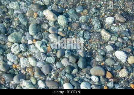 Stone beach with waves. Multi colore stones on beach Stock Photo