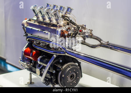 Inline four sport engine with polished exhaust and throttles Stock Photo