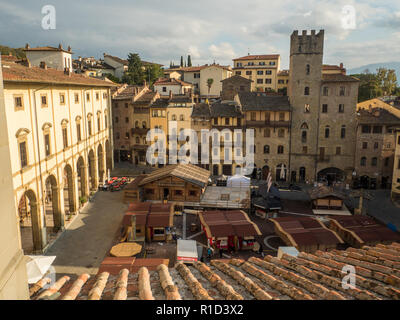 Medieval Piazza Grande, main town square in the city of Arezzo, Tuscany, Italy, with the wooden christmas market stalls. Stock Photo